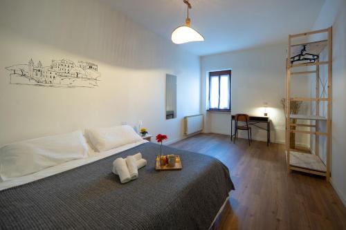 a bedroom with a bed with a tray with towels on it at Petra's House in Lenno