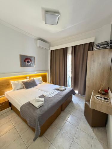 a bedroom with a large bed in a room at Villa Hara Suites in Paralia Katerinis