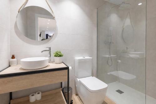 a bathroom with a toilet and a sink and a shower at Valencia Marina Apartment near Beach & City of Arts in Valencia
