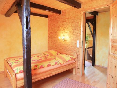 a bedroom with a bed with a pole in it at Ferienwohnungen Am Nussbaum in Saalfeld