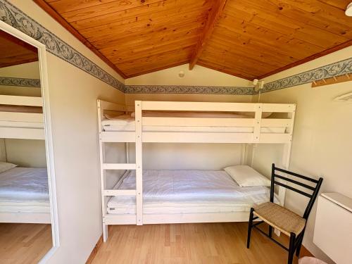 a room with two bunk beds and a chair at B&B Parkgården Leksand in Leksand