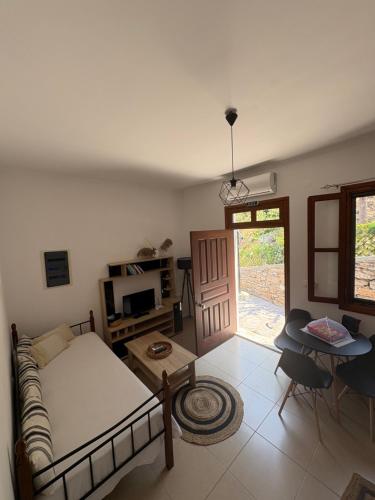 a living room with a bed and a table at Aelia studio in Symi