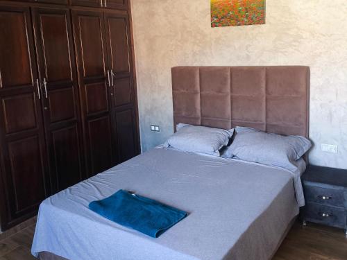 a bedroom with a bed with a blue blanket at Villa khaddouj Marrakech in Marrakesh