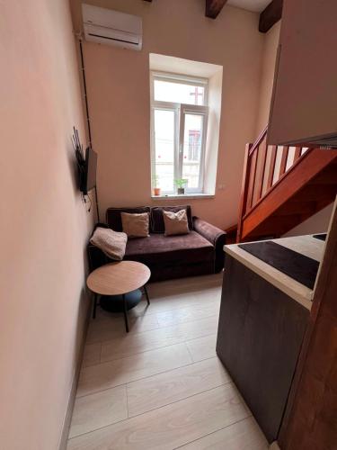 a small living room with a couch and a table at Chorni vivtsi in Chernivtsi
