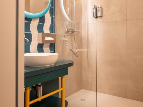 a bathroom with a sink and a shower at ibis Styles Brugge Centrum in Bruges