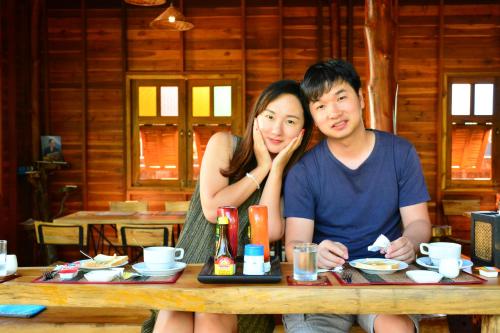 a man and a woman sitting at a table at The Choice Hotel - Adults Only in Bangkok