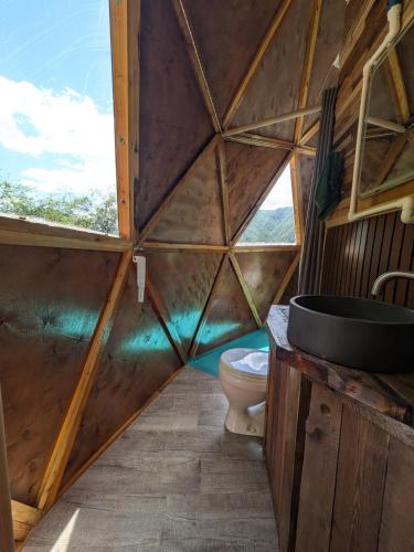 a wooden bathroom with a toilet and a window at Knowledge Temple - Keni in Kapan