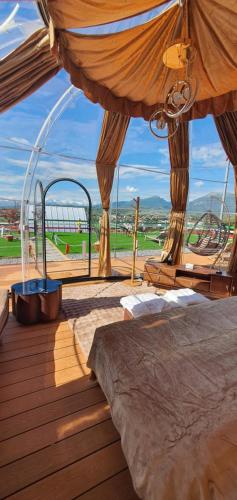 a room with two beds on a deck at Maremonti Glamping in Ancarano