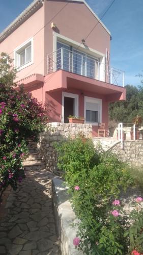 a pink house with flowers in front of it at evgenias studio 2 in Gaios