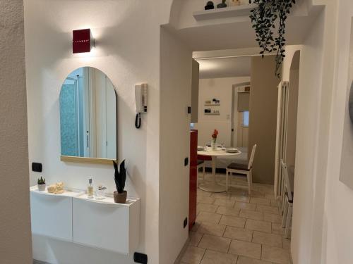 a bathroom with a sink and a mirror on a wall at In Bottega Apt 1 in Bosisio Parini