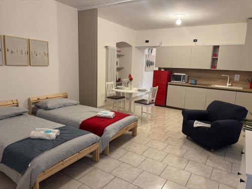 a living room with two beds and a kitchen at In Bottega Apt 1 in Bosisio Parini