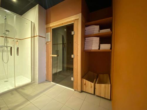 a bathroom with a shower and a glass shower door at Mercure Lille Marcq en Baroeul in Marcq-en-Baroeul