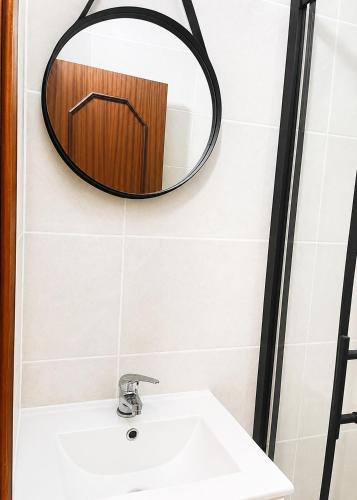 a bathroom with a sink and a mirror at Independent 2-room apartment in Senhora da Hora