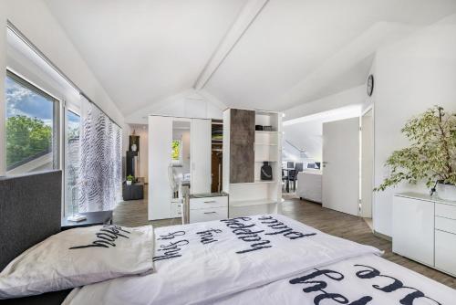 a bedroom with white walls and a large bed at Ferienwohnung Jeannette in Balingen