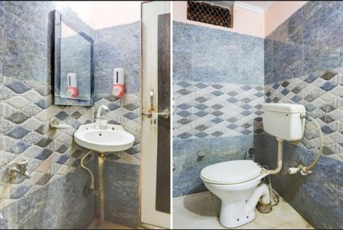 a bathroom with a toilet and a sink at Samrat Hotel in Sambhal