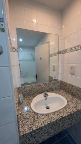 a bathroom with a sink and a mirror at Castelli Hotel Nicosia in Nicosia