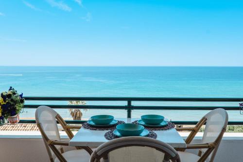 a table and chairs with a view of the ocean at Corfu Glyfada Beach Apartment 86 in Glyfada