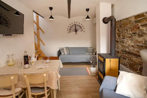 a small living room with a table and a couch at Apartmán Maštal in Osek