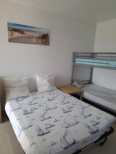a bed in a white room with a bunk bed at Césaria in Loupian