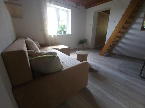 a living room with a couch and a window at Chata u lesa in Divec