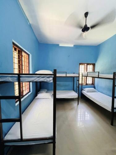 a room with three bunk beds and a ceiling at CK Enclave in Tripunittura