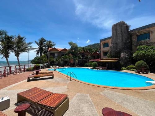 a large swimming pool next to a building at SWIMS! a Social Beach Resort in Haad Rin