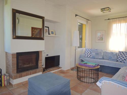 a living room with a fireplace and a mirror at Amaya in Begur