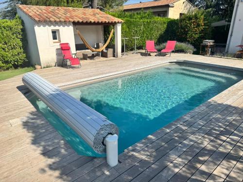a swimming pool with a slide in the middle of it at Appartement en Luberon in Pertuis