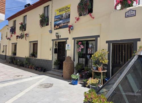 a building with potted plants in front of it at La Bastida Del Mirador in Diezma