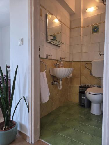 a bathroom with a sink and a toilet at Aegean Balcony in Tinos