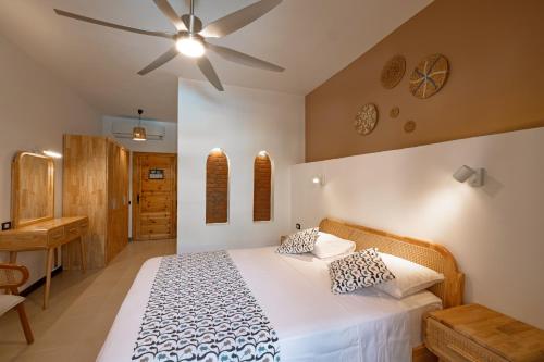 a bedroom with a bed and a ceiling fan at The Bridge Dahab in Dahab