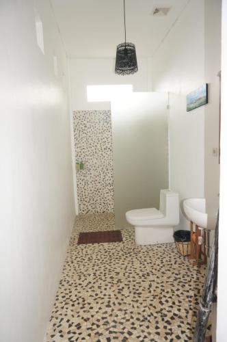 a bathroom with a toilet and a sink at Manggis Garden Dive Resort in Candidasa