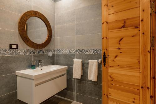 a bathroom with a white sink and a mirror at The Bridge Dahab in Dahab