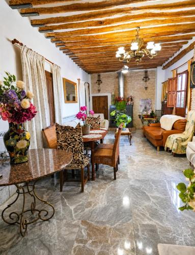 a living room with a table and chairs and a couch at La Bastida Del Mirador in Diezma