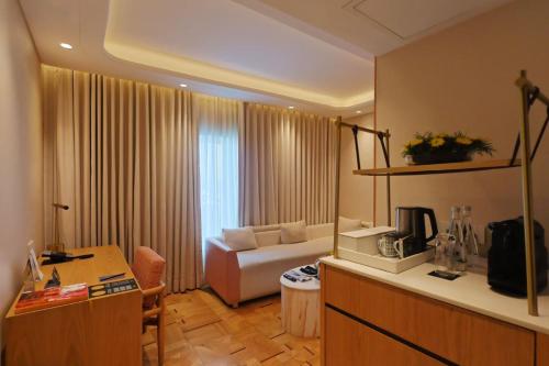 a living room with a couch and a table in a room at The Park New Delhi in New Delhi