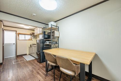 a kitchen and dining room with a table and chairs at Atlantis Tengachaya - Whole house rental in Osaka