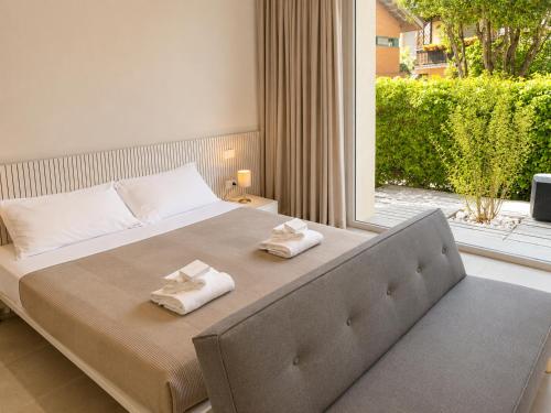 a bedroom with a large bed with towels on it at Amare Suite & Apartments in Bellaria-Igea Marina