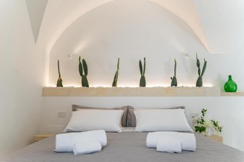 a bedroom with a bed with two pillows at "Corte Tedesco" - Apulian Luxury Suites in Brindisi