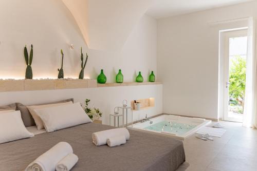 a bedroom with a bed and a bath tub at "Corte Tedesco" - Apulian Luxury Suites in Brindisi