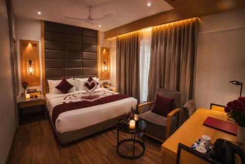 a hotel room with a bed and a desk at Varju Villa in Udaipur