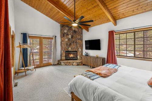 a bedroom with a bed and a fireplace at Spacious Flagstaff A-Frame Casita Getaway in Flagstaff