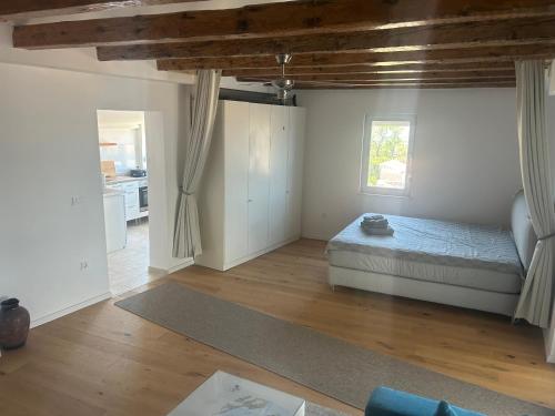 a bedroom with a bed and a living room at Apartmani Adi Tkon in Tkon