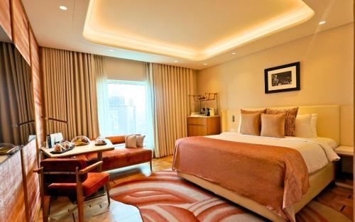 a hotel room with a large bed and a desk at The Park New Delhi in New Delhi