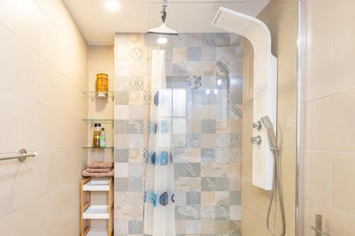 a bathroom with a shower with a glass door at Blue Emi Altea Hills in Altea la Vieja