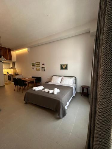a bedroom with a bed with two towels on it at Mezzo Patmos Apartments in Patmos