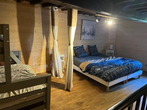 a bedroom with a bed in a log cabin at Gîte des vergnioux in Ayat-sur-Sioule