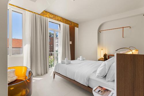 a bedroom with a large bed and a large window at Naomi Cannes in Cannes