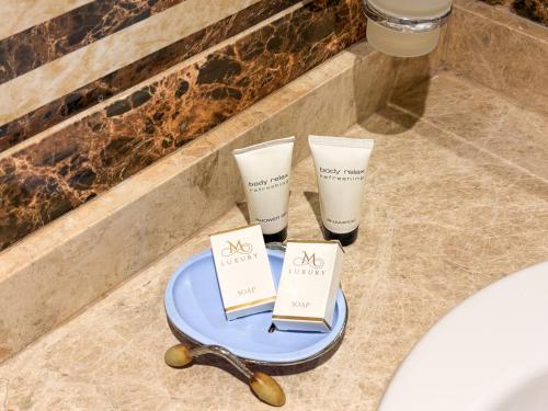 a blue plate with two candles on a bathroom counter at Beirut Hotel Cairo in Cairo