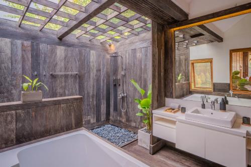 a bathroom with a tub and a sink and a shower at Ocean & Mountain View Villa, Waterfalls, Munduk Eco-Luxe by Santrian in Munduk