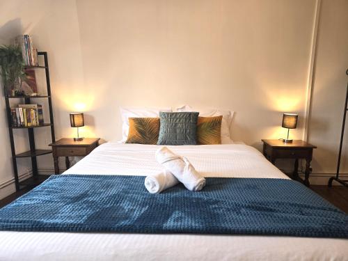 a bedroom with a large bed with towels on it at LE MATIN CALME - Charme ancien - Vue canal in Dole